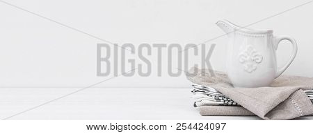 Long Banner White Vintage Pitcher On Stack Of Linen Cotton Towels. Kitchen Interior Home Textile. St
