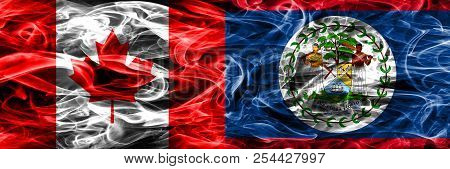Canada Vs Belize Smoke Flags Placed Side By Side. Canadian And Belize Flag Together