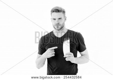 Bearded Man Point Finger At Shampoo Or Gel Bottle. Macho With Beard In Tshirt Show Cosmetic For Bath