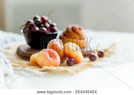 Homemade Cinnamon Buns In Glaze On A Dark Plate With Berries