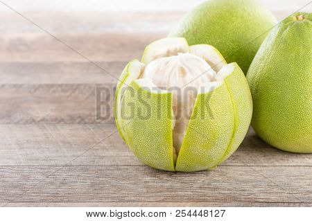 Fresh And Peeled Pomelo(shaddock), Grapefruit With Slices On Wooden Table Background