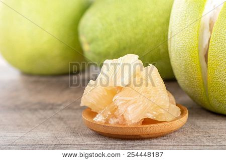 Fresh And Peeled Pomelo(shaddock), Grapefruit With Slices On Wooden Table Background