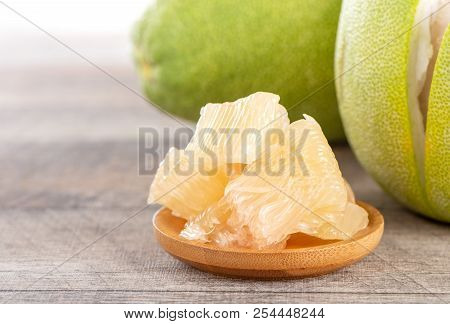 Fresh And Peeled Pomelo(shaddock), Grapefruit With Slices On Wooden Table Background