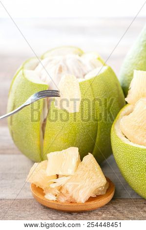 Fresh And Peeled Pomelo(shaddock), Grapefruit With Slices On Wooden Table Background