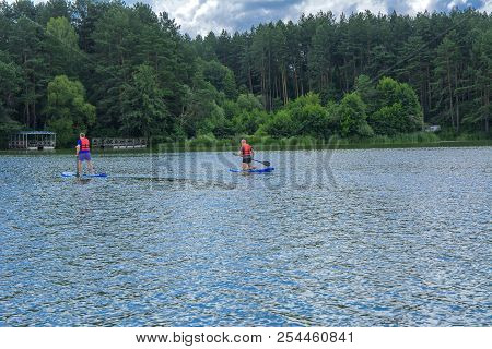 Zhytomyr, Ukraine - July 16, 2018. Athletes Conduct Training On High-speed Swimming Kayak (kayaking)