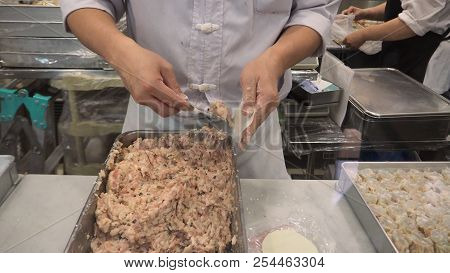 Blurry Image Of Man Or Chef Is Making Dim Sum. By Dumpling Wrappers.