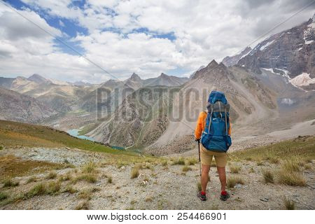 Wanderlust time. Man hiking in beautiful Fann mountains in Pamir, Tajikistan. Central Asia.