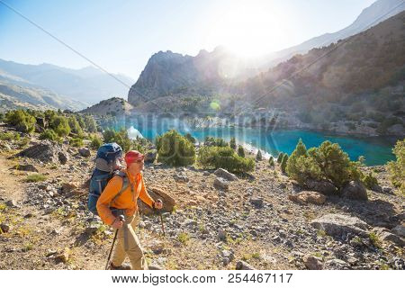 Wanderlust time. Man hiking in beautiful Fann mountains in Pamir, Tajikistan. Central Asia.
