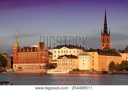 Stockholm, Sweden. Skyline Of Riddarholmen Island Seen Across Riddarfjarden Channel. Sunset Light.