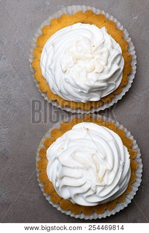 Delicious Merengue Dessert. Lemon Tartlet Tart With With Meringue On Grey Stone Concrete Table Backg