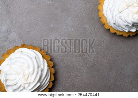 Delicious Merengue Dessert. Lemon Tartlet Tart With With Meringue On Grey Stone Concrete Table Backg