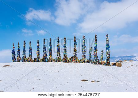 Wooden Ritual Pillars With Colorful Ribbons On Cape Burkhan, Lake Baikal, Olkhon Island, Siberia, Ru