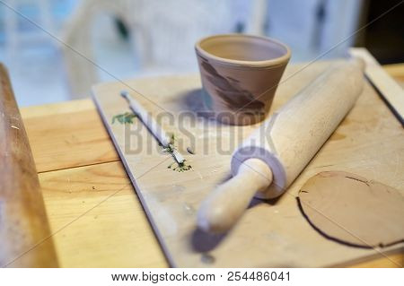 Earthenware. Ceramic Products From Raw Clay. Mug, Stack, Rolling Pin Lying On A Wooden Table. Art Th