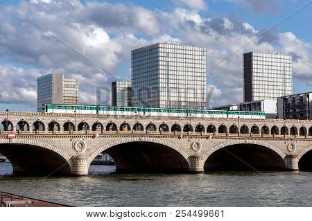 Paris, France - August 13, 2018: Metro Crossing Bercy Bridge With National Library Of France In Back