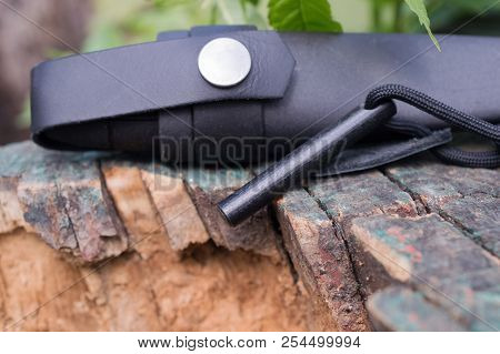 Hunting Knife In The Case And With The Flint Lies On The Stump