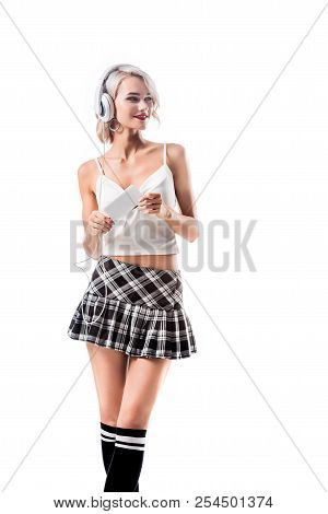 Portrait Of Beautiful Seductive Schoolgirl With Smartphone Listening Music In Headphones Isolated On Portrait Of Beautiful Seductive Schoolgirl With Smartphone Listening Music In Headphones Isolated On