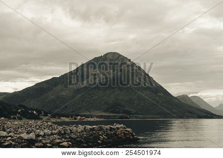 Mountains In Northern Norway, Cold Blue Ocean And White Beaches