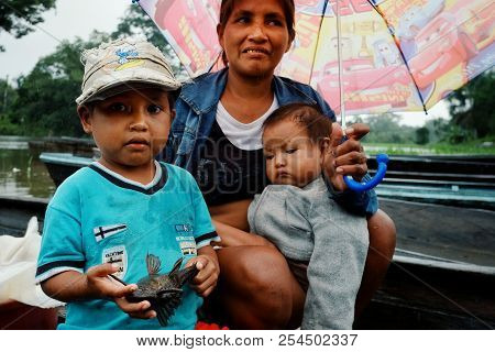 Macedonia, Amazonia / Colombia - Mar 15 2016: Local Family From A Rainforest Jungle Village Coming B