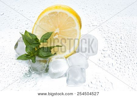 Lemon Ring With Ice And Mint On A Silvery Background Closeup