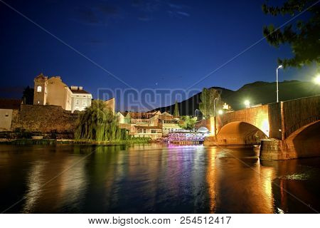 colorful light reflection of Trebinje town on Trebisnjica river at night, Bosnia And Herzegovina