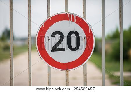 Round Road Sign On The Gate With A Speed Limit Of 20 Miles Per Hour