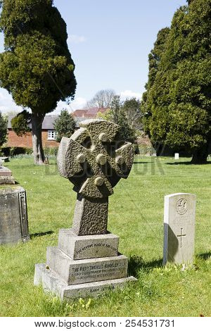 Winslow, Uk - April 27, 2015. Gravestone With Cross At A Church Graveyard In The Historic Town Of Wi