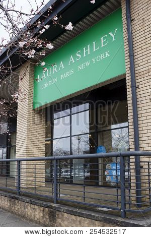 Milton Keynes, Uk - March 29, 2018. Trees Blossom Outside A Laura Ashley Store. Shares In Laura Ashl
