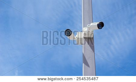 Cctv Surveillance Security Camera Video And Blue Sky Concept - Cctv Surveillance Security Camera Vid