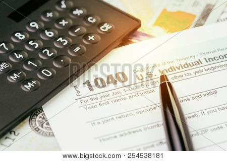 Tax Submission Or Revenue Calculation Concept, Pen On 1040 Us Individual Income Tax Filling Form Wit
