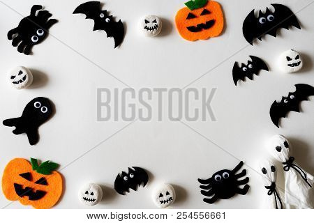 Top View Of Halloween Crafts, Orange Pumpkin, Ghost And Spide On White Background With Copy Space Fo