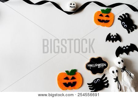 Top View Of Halloween Crafts, Orange Pumpkin, Ghost And Spide On White Background With Copy Space Fo