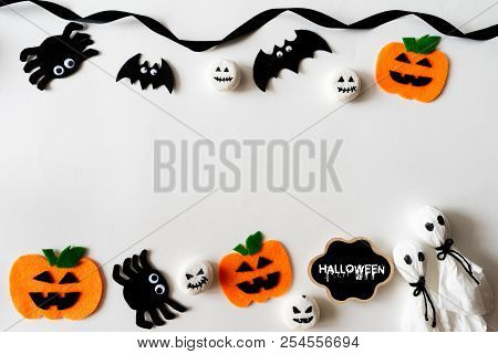 Top View Of Halloween Crafts, Orange Pumpkin, Ghost And Spide On White Background With Copy Space Fo