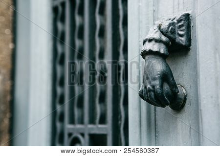 Close-up. Vintage Handle For Knocking On The Door In The Form Of A Hand. Entrance To The Apartment B