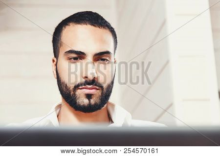 Close Up Portrait Of Bearded Multicultural Enterpreneur Man Working With Laptop In The Comfortable L