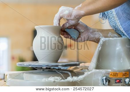 Creating A Jar Or Vase Of White Clay Close-up. Master Crock. Man Hands Making Clay Jug Macro. The Sc