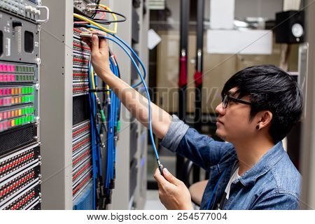 Young Man Connecting Wire Video In Path Panel That Is Equipped For Broadcast.