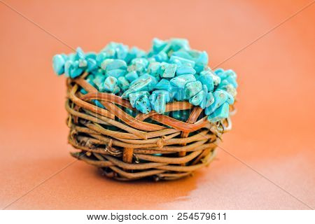 Pile Stones Of Raw Turquoise In Small Wooden Nest On A Brown Background. Blue And Green Color Stones