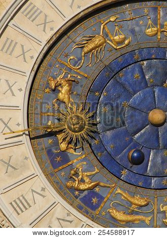 Ancient time, astrology and horoscope. Detail of Saint Mark Square old Clocktower with Autumn and Winter zodiac signs, planets and stars (15th century)