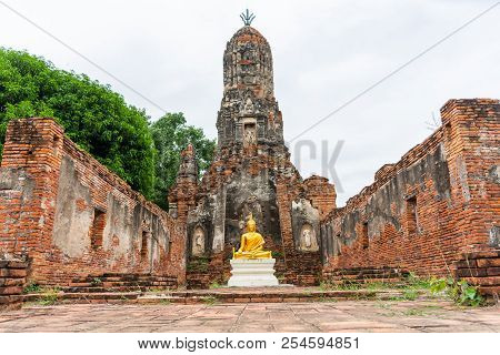 Beautiful Golden Buddha Image In Front Of Old Pagoda In Ancient Ruined Buddhist Temple In Ayutthya, 
