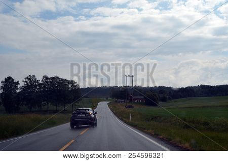 A typical Norwegian road in the countryside. June 16. 2018. Ostfold Region, Norway