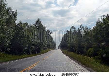 A typical Norwegian road in the countryside. June 16. 2018. Ostfold Region, Norway