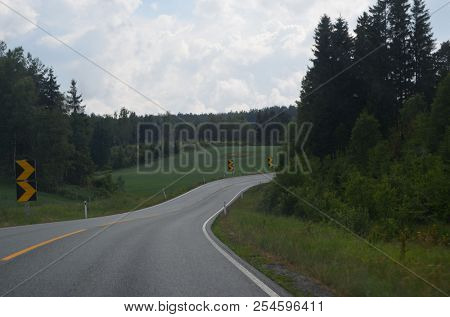 A typical Norwegian road in the countryside. June 16. 2018. Ostfold Region, Norway