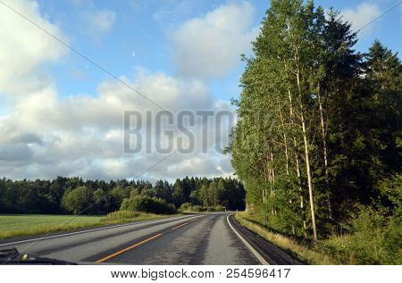 A typical Norwegian road in the countryside. June 16. 2018. Ostfold Region, Norway