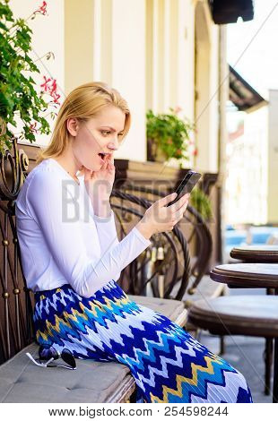 Shocking Content. Girl Communicating With Friend Using Smartphone. Woman Surprised Face Surfing Inte