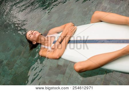 Beautiful Cute Woman In Sexy Bikini In Pool Hold Her Custom Longboard Single Fin Surfing Board To Te