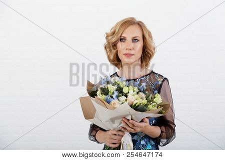 Portrait Of A Woman With A Bouquet Of Flowers In Her Hands
