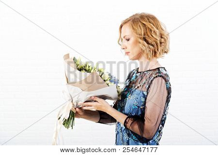Portrait Of A Woman With A Bouquet Of Flowers In Her Hands
