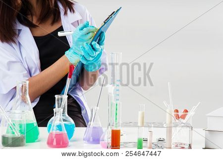 The Chemist In White Uniform Nad Wear Rubber Blove Is Working By Test Tube With Reagent In Lab,she I