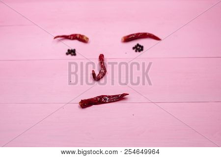In Selective Focus Of The Horizental Dried Chili,on Pink Pastel Timber Board,blurry Light Design Bac