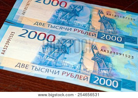 Russian Two Thousandth Notes Close-up Against The Background Of A Dark Wooden Table